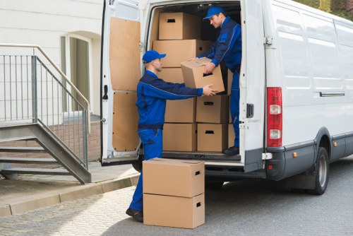 Movers carrying furniture from a Putney flat